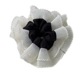 Elegant black satin and white lace scrunchie with layered wavy mesh edges for hair styling