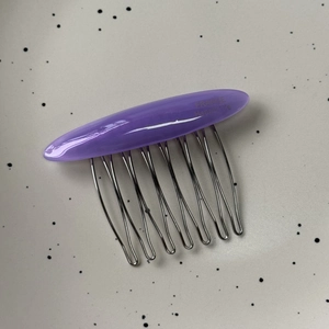 Detailed macro view of purple acetate hair comb featuring France Handmade engraving