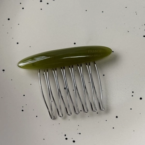 Detail of olive green marbled hair comb with gold France Handmade engraved text