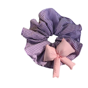 Checkered hair scrunchie with a large pink bow, elegant ballet core style hair accessory