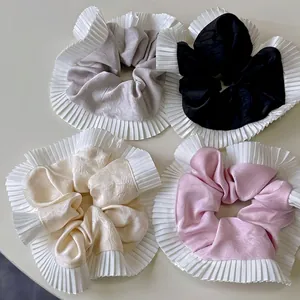 Set of four satin scrunchies with white pleated chiffon edges in neutral and pastel colors
