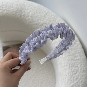 Detail shot of lilac tulle lace headband with ruffled layers on soft white background