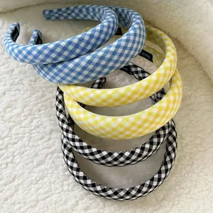 Classic plaid padded headbands in blue and yellow colors on white plush background