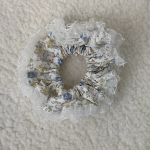 Floral lace hair scrunchie with blue and yellow flower patterns on soft fabric
