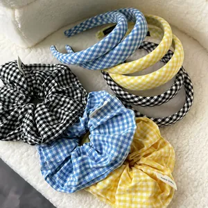 Detail of plaid headband and matching scrunchie set in black, blue and yellow