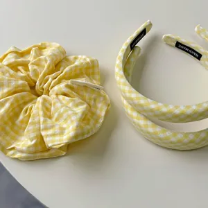Close-up of handmade yellow plaid headband set and scrunchie with detailed stitching