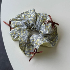 Floral cotton scrunchie in grey and yellow with three small chocolate brown ribbon bows