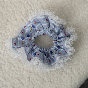 Detail of floral lace hair scrunchie with red hearts and blue flower patterns