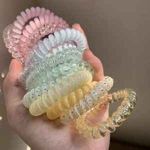 Set of four pastel colored spiral telephone wire hair ties in soft macaron shades