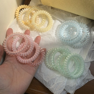 Set of 4 pastel spiral telephone wire hair ties in pink, blue, yellow, and green colors