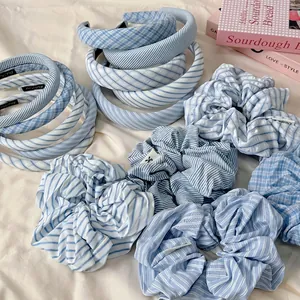 Blue and white striped padded headbands and scrunchies set on white fabric