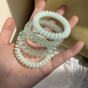 Set of 4 pastel spiral telephone wire hair ties including mint green and clear resin colors