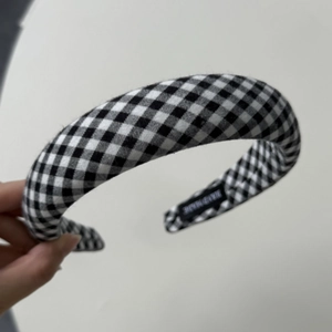Macro detail of hand made label on black and white gingham plaid padded headband