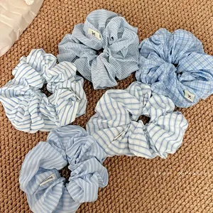 Set of six blue and white striped fabric scrunchies for elegant ponytail styling