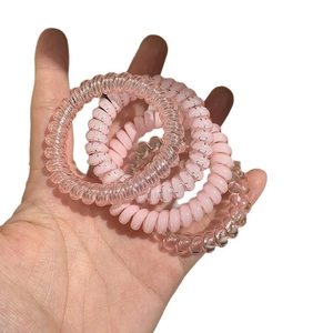 Set of 4 pink spiral telephone cord hair ties in solid and translucent matte finishes