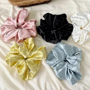 Five-pack polka dot satin scrunchies in pastel colors including pink black and blue