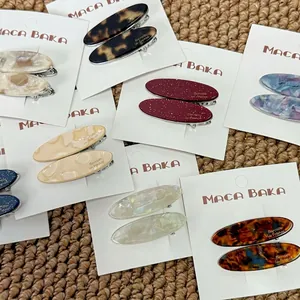 Elegant tortoiseshell acetate willow leaf hair clips set on rustic woven background