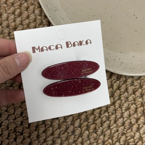 Sparkly burgundy resin oval hair clips set on display card for elegant styling