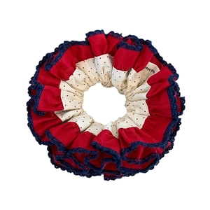 Retro red polka dot scrunchie with lace trim for elegant high bun hairstyles