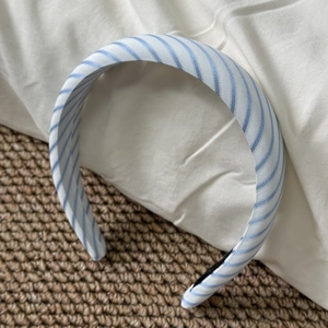 Detail of blue and white striped fabric headband with black non-slip inner padding