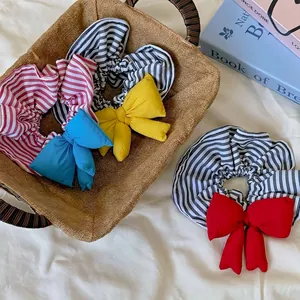 Chic striped oversized scrunchie with a 3D padded bow accent for stylish hair styling