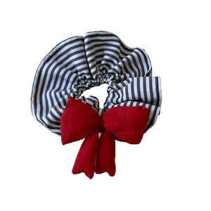 Chic scrunchie with black and white stripes and a large red bow decoration