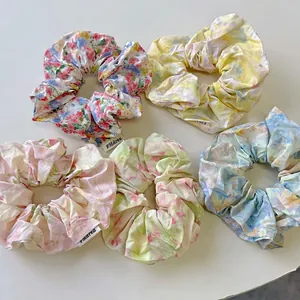 Five-piece set of floral oil painting style scrunchies in pastel colors on white background