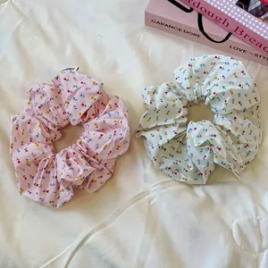 Chic floral fabric scrunchies set in pink and white patterns for elegant hair styling