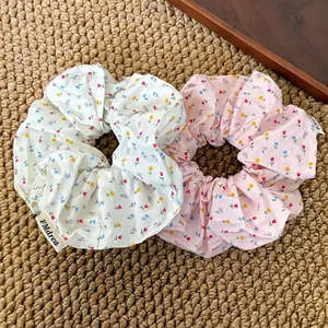 Floral chiffon scrunchies in white and pink colors for a fresh pastoral hairstyle