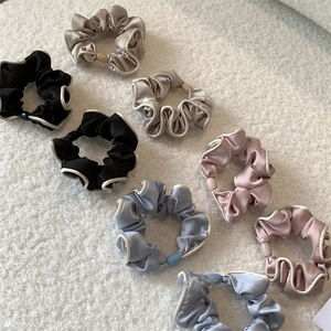 7-piece French style satin scrunchie set with white piping on fuzzy lamb wool background