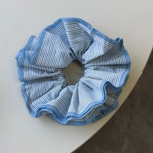 Detailed view of large blue and white striped scrunchie with precision stitched edges
