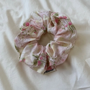 Detailed macro view of the oil painting style pink rose floral scrunchie texture