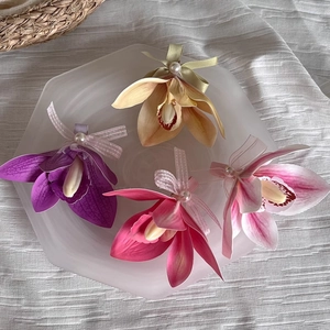 Set of four magnolia flower duckbill hair clips with silk texture and pearl accents