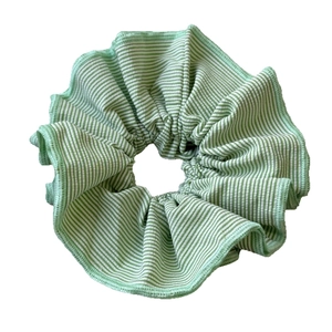 Green and white striped scrunchie hair tie with soft pleated fabric and elastic core