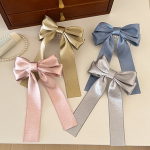 Set of four elegant metallic satin bow hair clips in gold, pink, blue and silver finishes