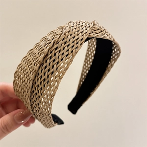 Breathable woven raffia headband in khaki featuring a stylish crisscross braided design
