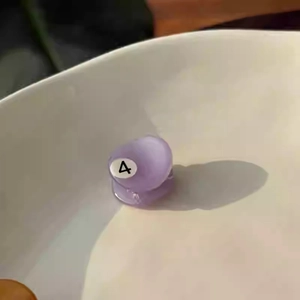 Close-up of small purple acetate billiard hair claw clip with glossy finish