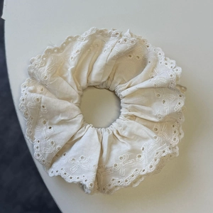 Elegant cream white lace scrunchie with detailed eyelet embroidery for women's hair