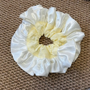 Detail of large oversized double-layer satin scrunchie with white polka dots pattern