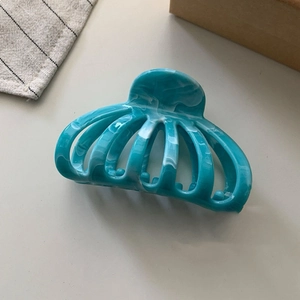Blue marble patterned hair claw clip with vintage cutout shell design for hair styling