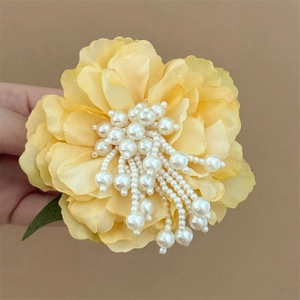 Floral hair clip with pearls and long tassel fringe for elegant summer hairstyles