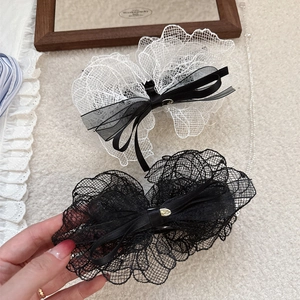 Lace bow hair claws in black and white colors with elegant French style ribbon design