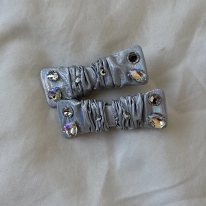 Silver metallic fabric bow hair clips with sparkling rhinestones in Y2K style fashion