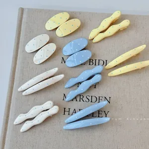 Chic polka dot geometric hair clips set in pastel colors on linen texture background