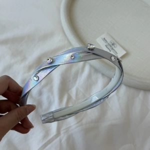 Detail showing laser silver headband with iridescent fabric and sparkling rhinestones