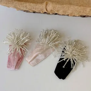 Pink, beige, and black velvet hair clips with elegant silver fireworks bead decorations