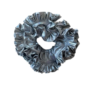 Metallic silver pleated scrunchie with iridescent finish for a stylish hair accessory