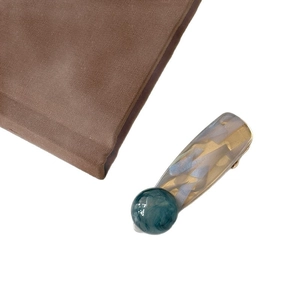 Korean style marble texture hair clip with dark green bead on white background