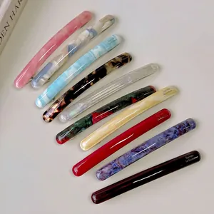 Set of ten colorful acetate baguette spring hair clips in marble and tortoiseshell patterns