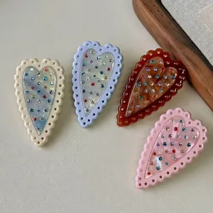 Set of four colorful French heart-shaped hair clips with rhinestones for women
